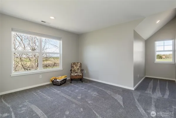 an empty room with windows and closet