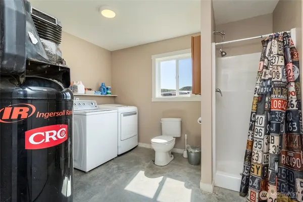 a utility room with sink dryer and washer