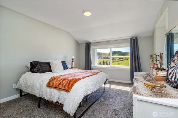 a bedroom with a bed and window