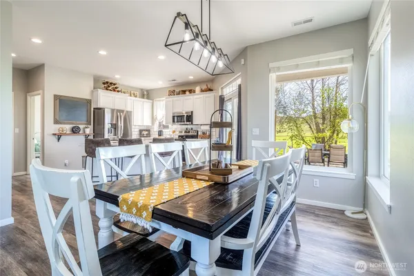 a view of a dining room with furniture window and wooden floor