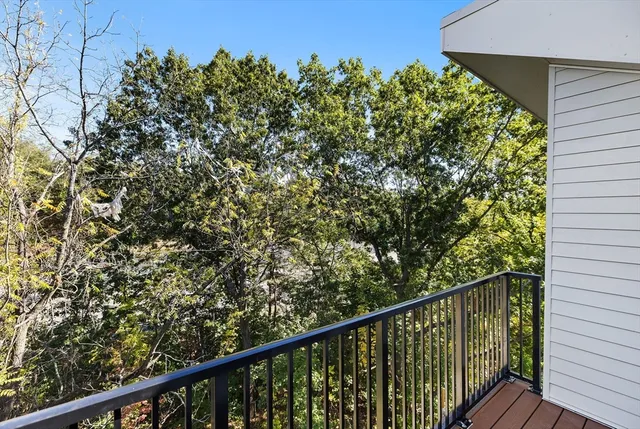 a balcony with trees in front of it