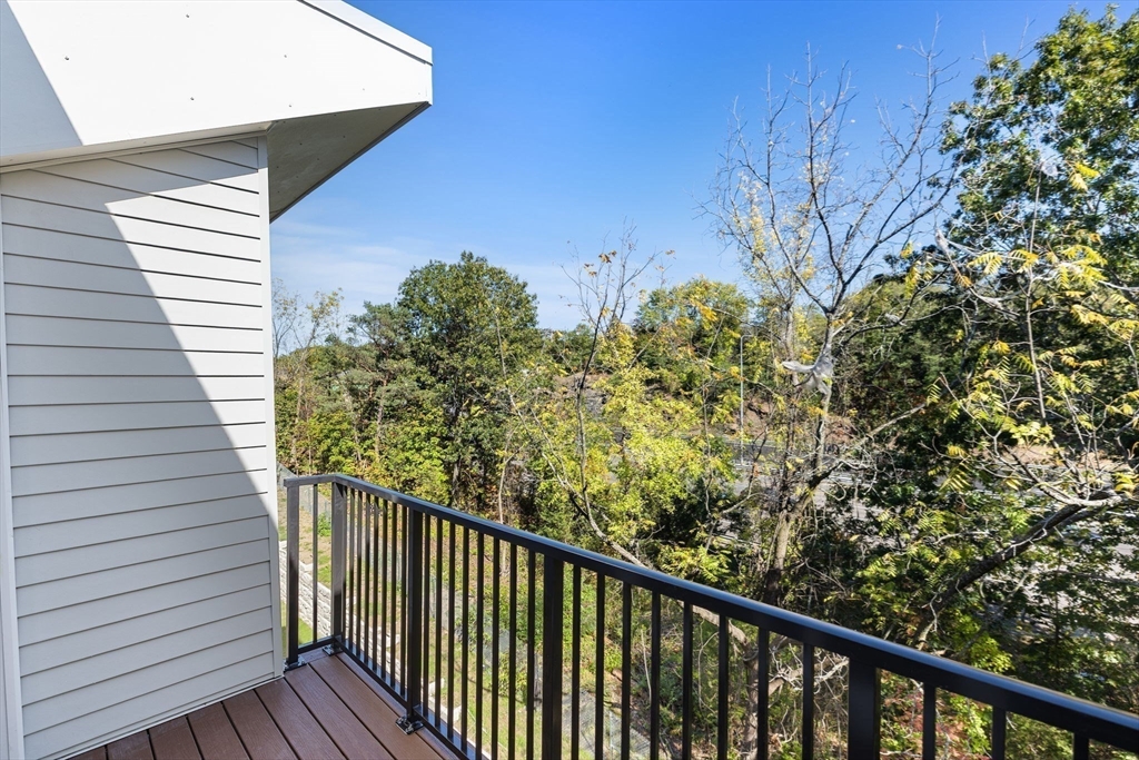 59 Mill Street, Unit 116 Woburn, MA 01801 - Photo 23 of 23 a view of a balcony with wooden fence