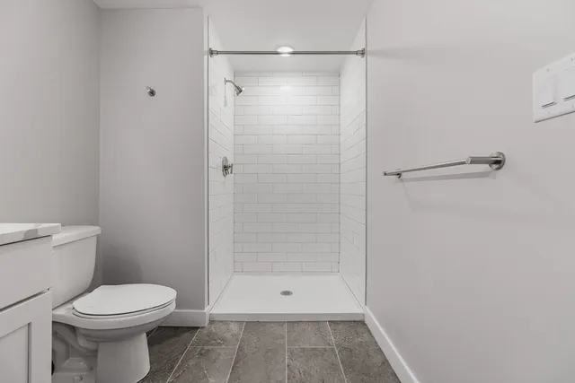 a bathroom with a shower and a toilet