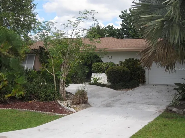 a view of a house with a yard and plants