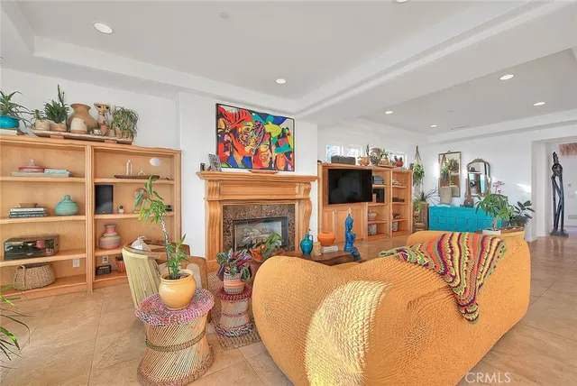 a living room with furniture fireplace and a large window