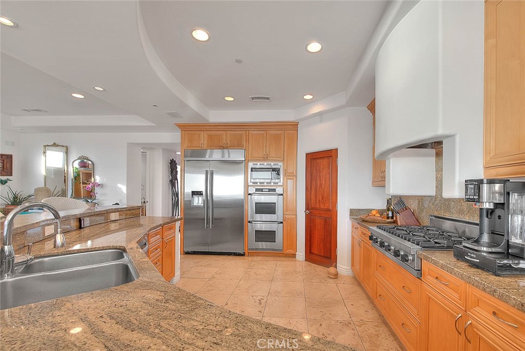 35177 Beach Road Dana Point, CA 92624 - Photo 25 of 66 a large kitchen with stainless steel appliances kitchen island granite countertop a large counter top cabinets and stainless steel appliances