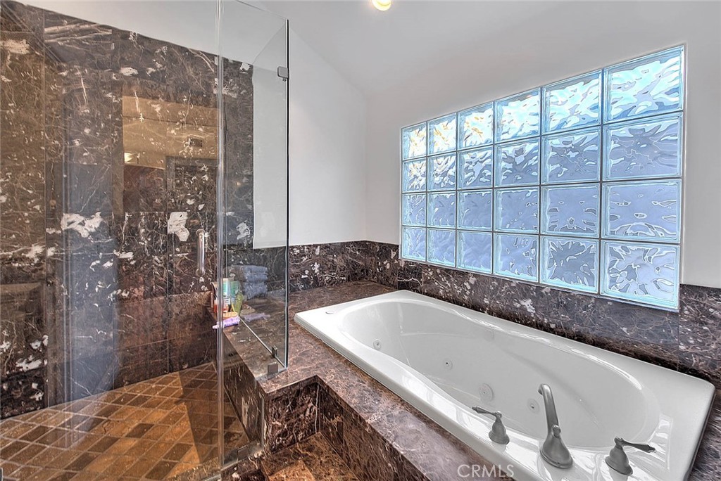 35177 Beach Road Dana Point, CA 92624 - Photo 35 of 66 a bathroom with a bathtub and shower