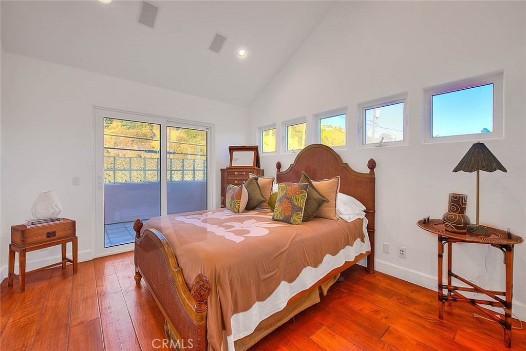 35177 Beach Road Dana Point, CA 92624 - Photo 39 of 66 a bedroom with a bed a dresser with wooden floor
