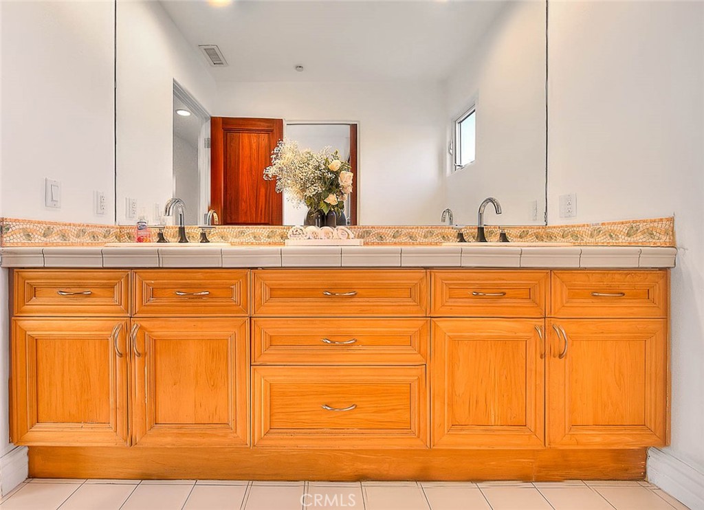 35177 Beach Road Dana Point, CA 92624 - Photo 40 of 66 a bathroom with a sink a vanity and mirror