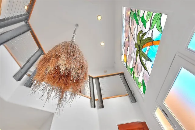 a living room with furniture and floor to ceiling windows