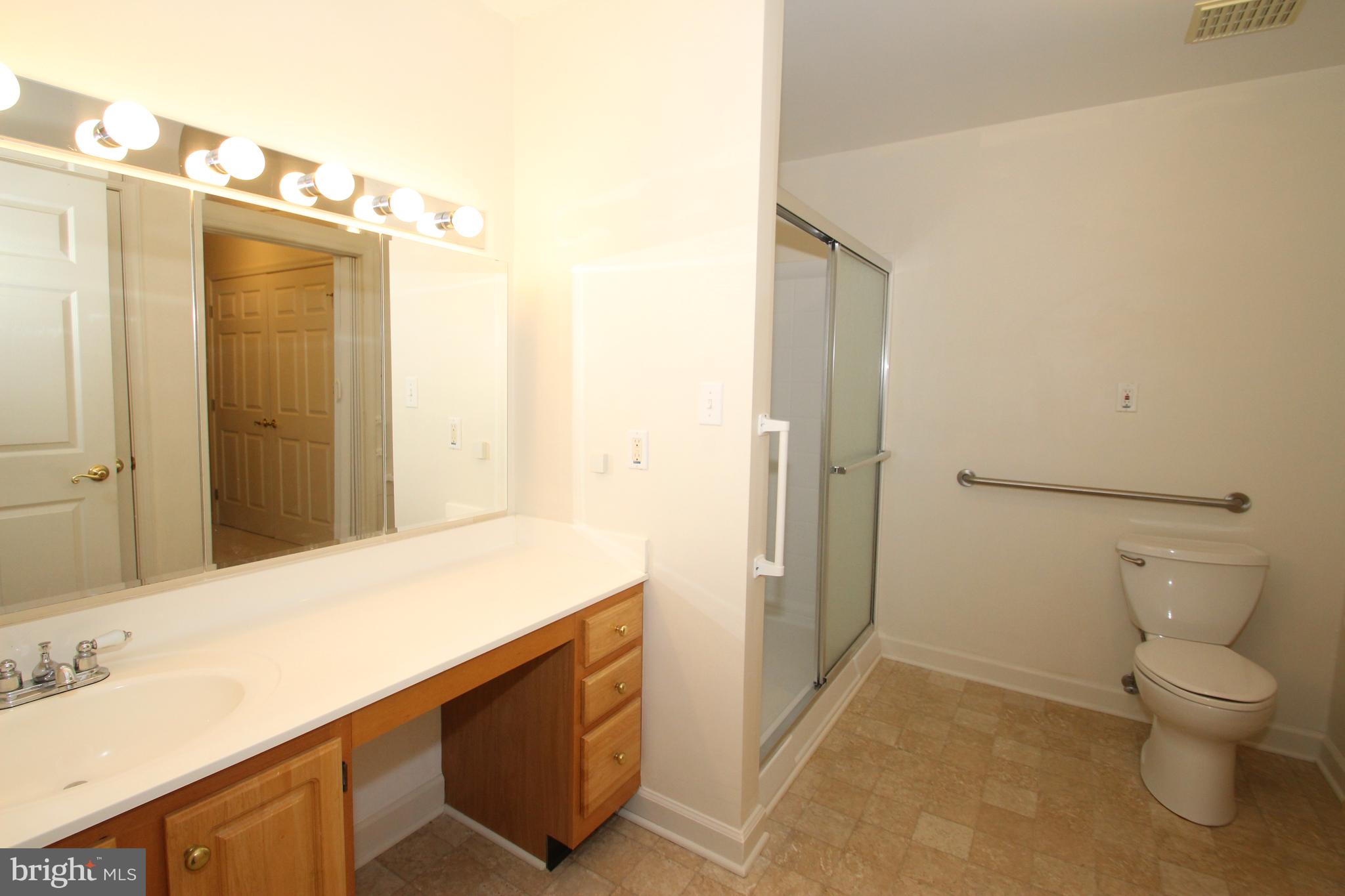 30 West Village Road Newark, DE 19713 - Photo 7 of 13 a bathroom with a granite countertop sink a toilet and shower