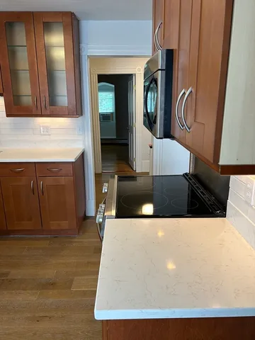 a view of living room kitchen with furniture and wooden floor