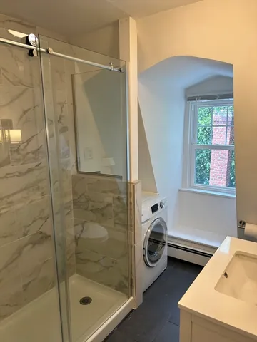 a bathroom with a tub and a window