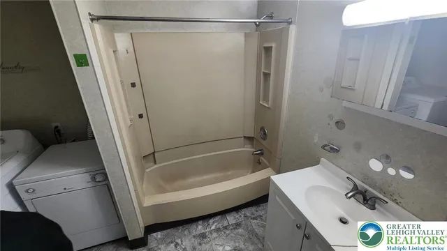 a bathroom with a tub and a sink
