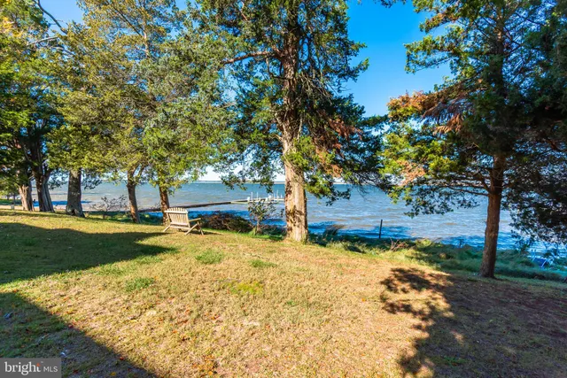 a kitchen with stainless steel appliances granite countertop a refrigerator a stove and a sink with cabinets