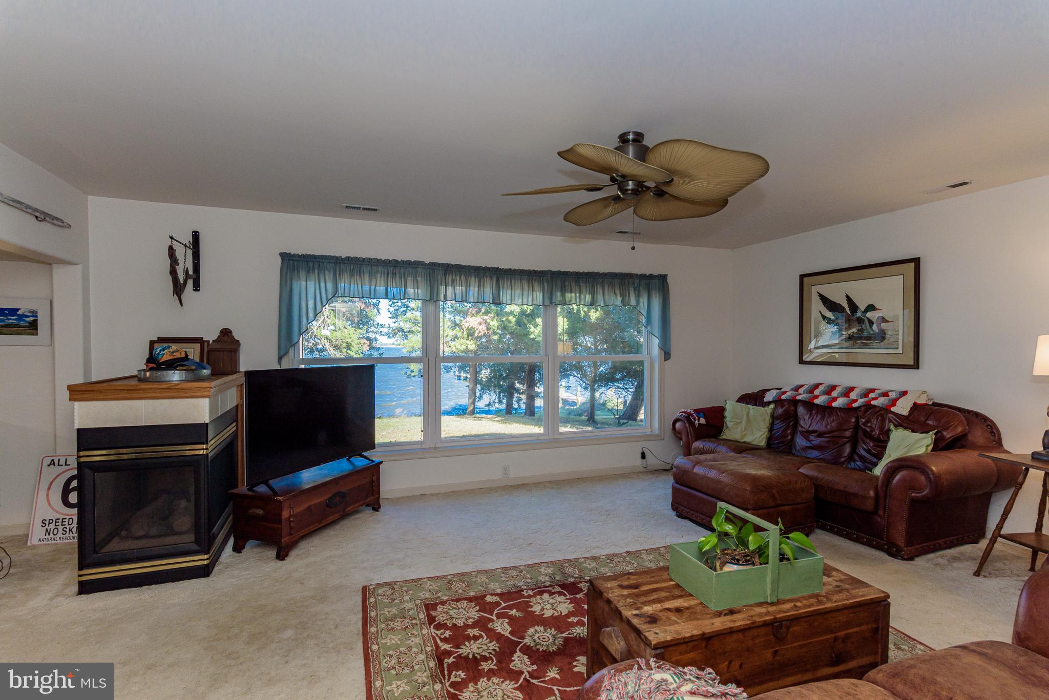 26388 Mt Vernon Road Princess Anne, MD 21853 - Photo 22 of 43 a living room with furniture a flat screen tv and a window
