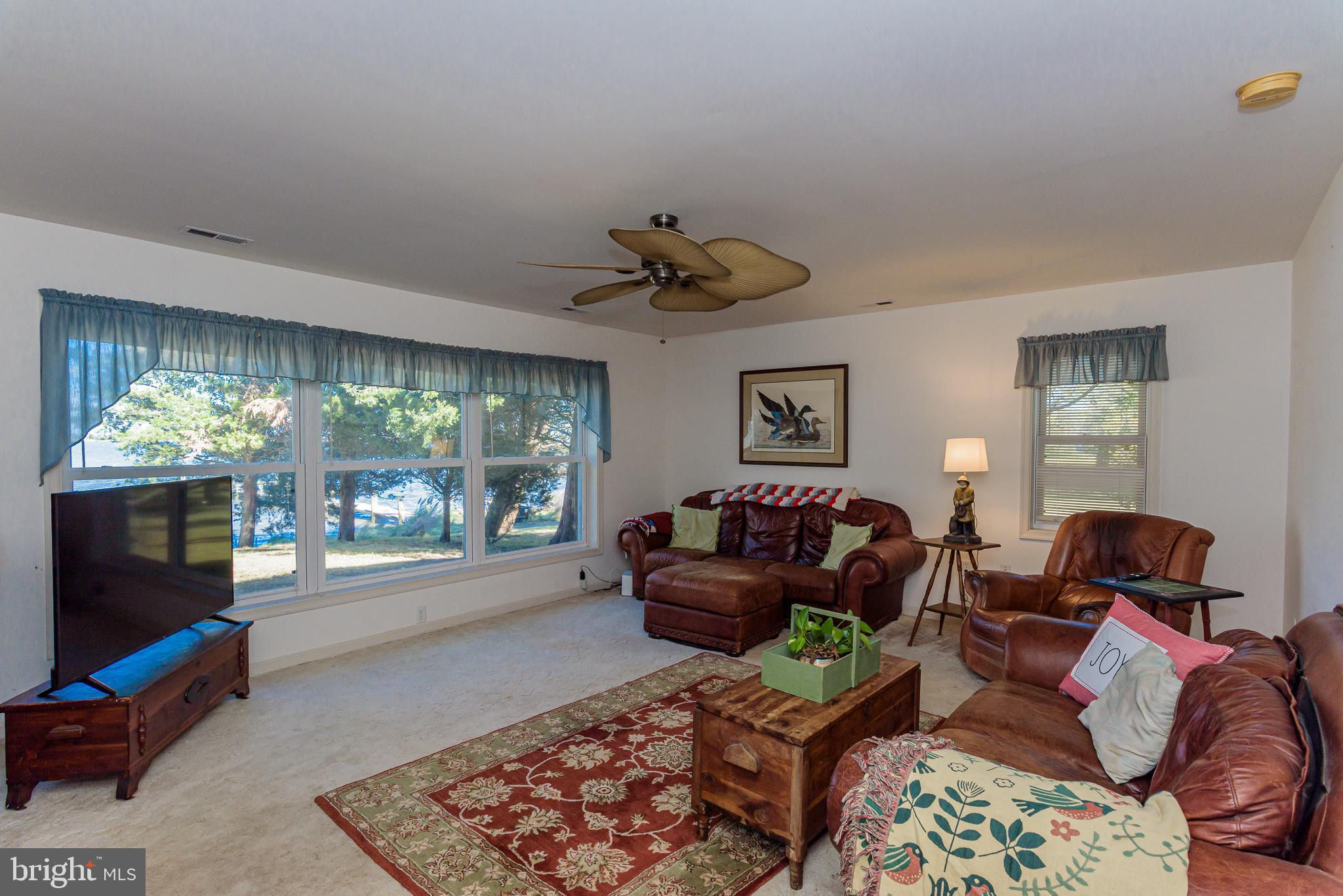 26388 Mt Vernon Road Princess Anne, MD 21853 - Photo 23 of 43 a living room with furniture and a flat screen tv