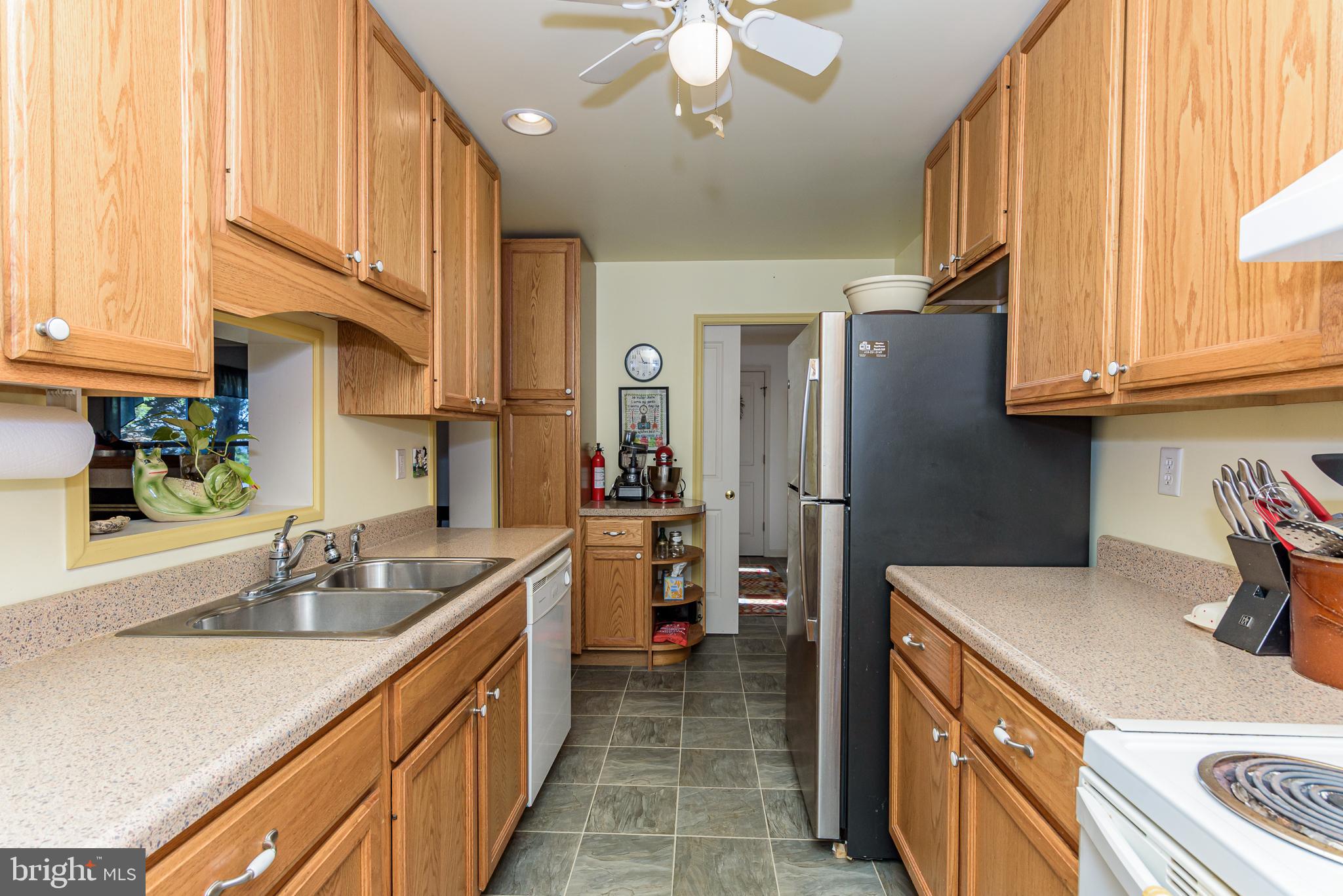 26388 Mt Vernon Road Princess Anne, MD 21853 - Photo 26 of 43 a kitchen with a sink a refrigerator and cabinets