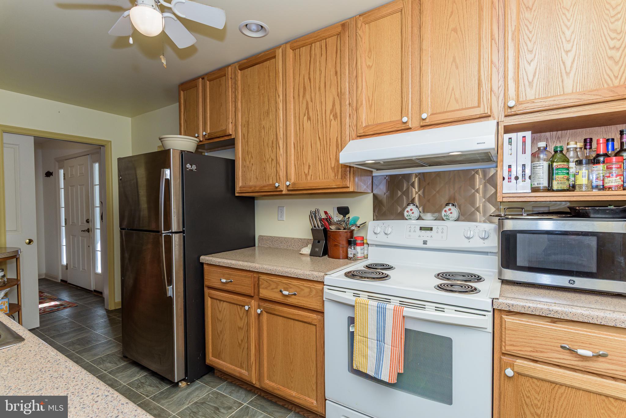 26388 Mt Vernon Road Princess Anne, MD 21853 - Photo 27 of 43 a kitchen with stainless steel appliances granite countertop a refrigerator a stove and a sink
