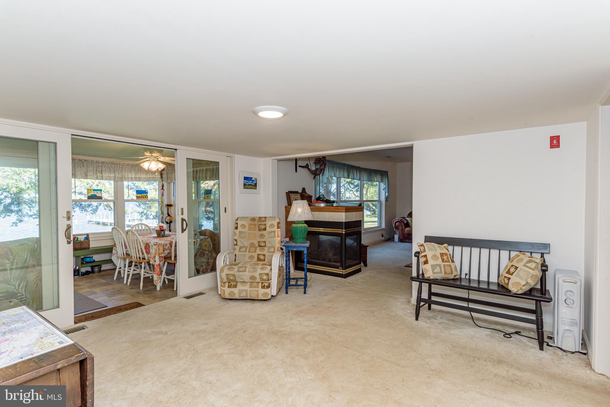 26388 Mt Vernon Road Princess Anne, MD 21853 - Photo 30 of 43 a living room with furniture and a flat screen tv