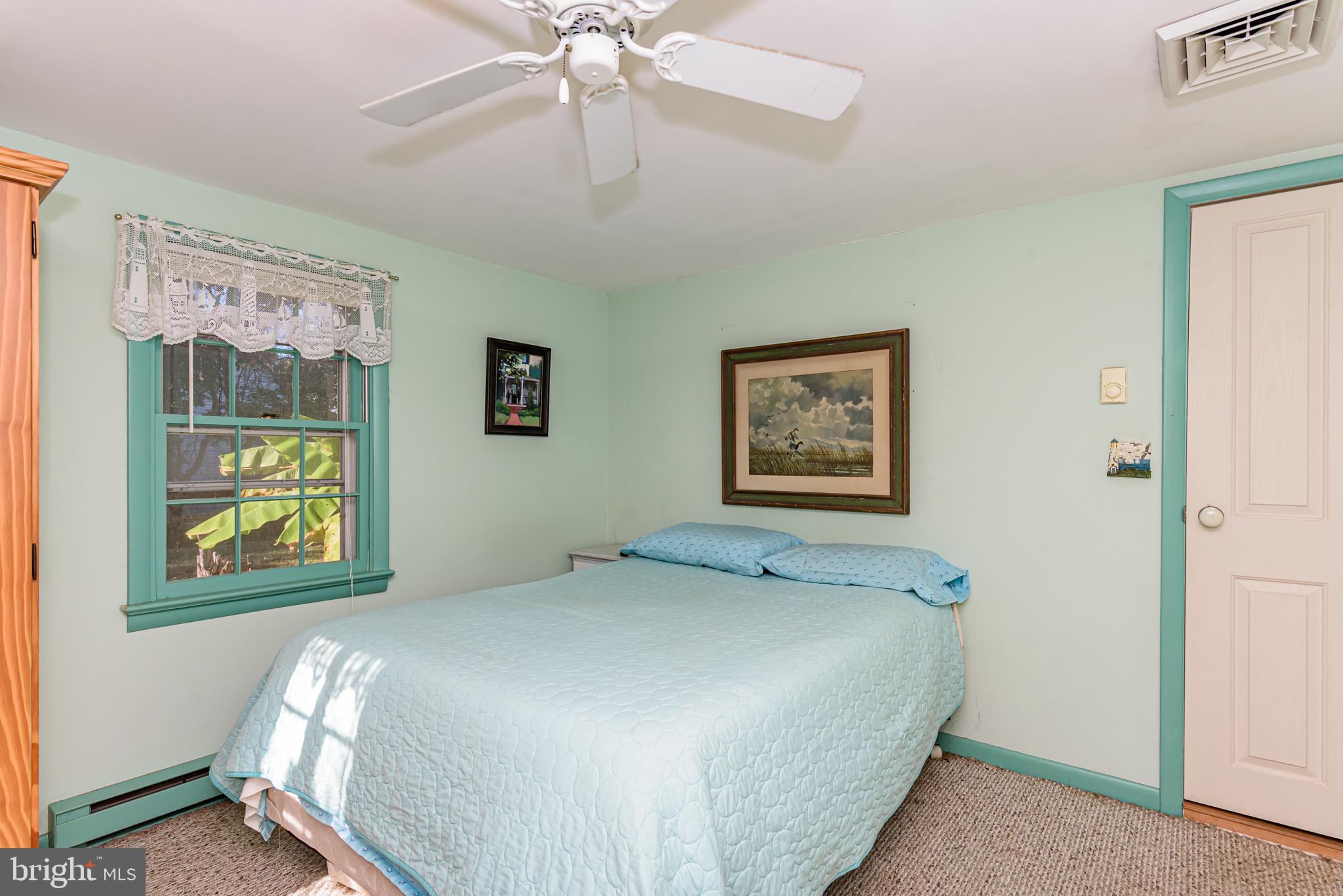 26388 Mt Vernon Road Princess Anne, MD 21853 - Photo 38 of 43 a bedroom with a bed and painting on the wall