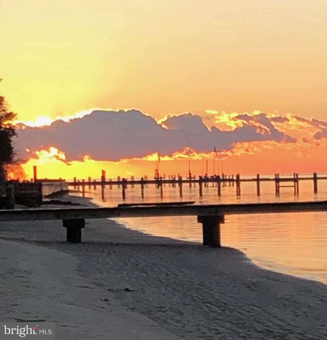 26388 Mt Vernon Road Princess Anne, MD 21853 - Photo 4 of 43 a view of swimming pool with a table potted plants with wooden floor and lake view