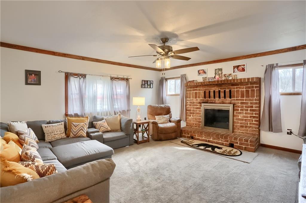 1923 Martin Road New Castle, PA 16101 - Photo 2 of 25 a living room with furniture a fireplace and a flat screen tv