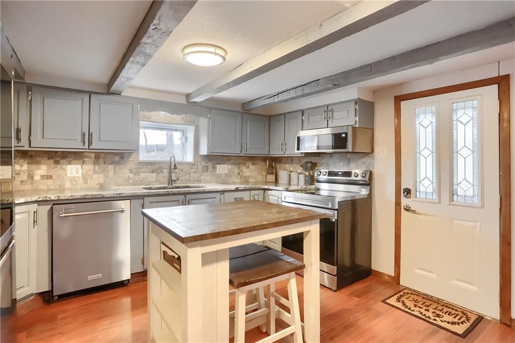 1923 Martin Road New Castle, PA 16101 - Photo 8 of 25 a kitchen with a stove a sink and a refrigerator