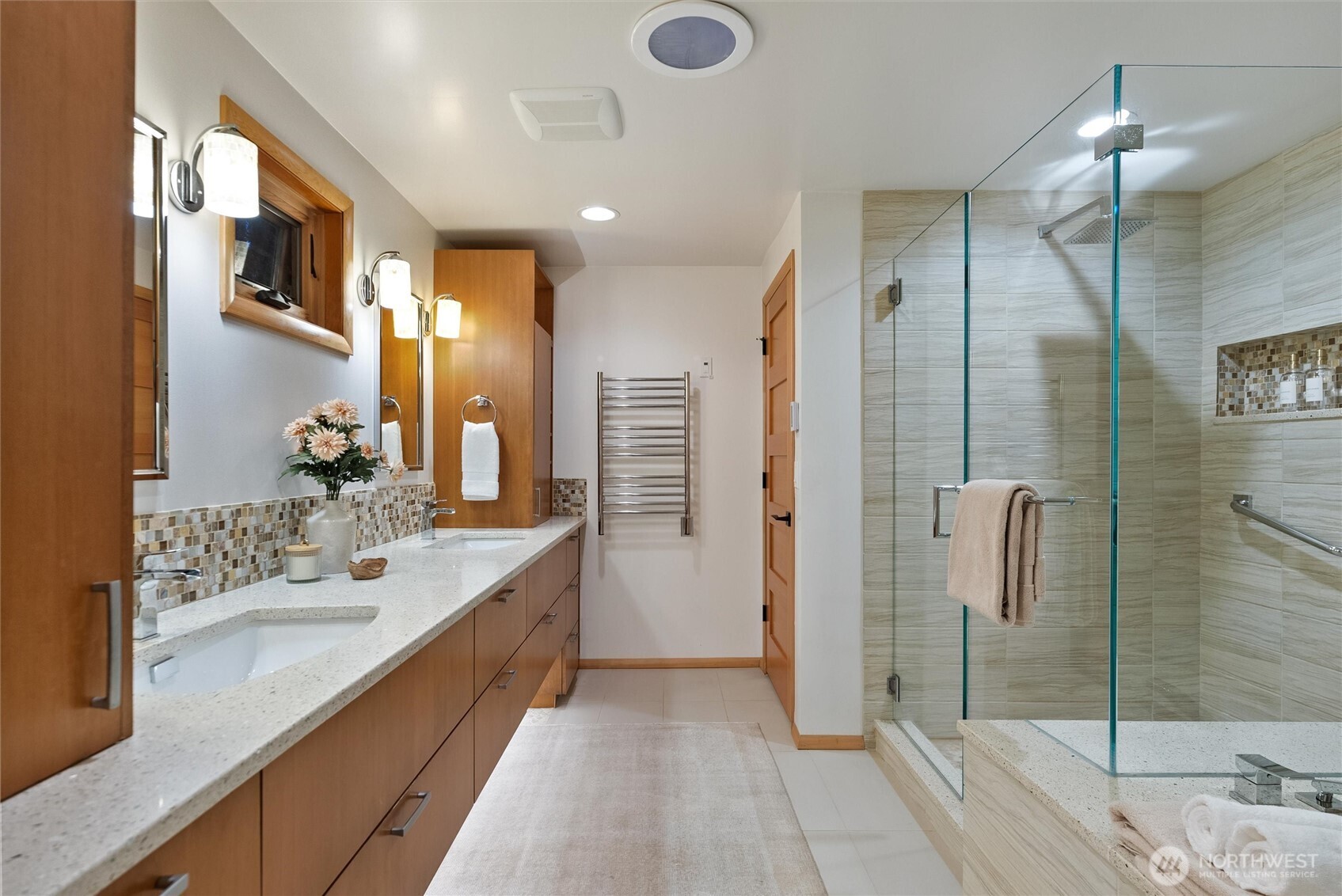18431 High Street Edmonds, WA 98020 - Photo 18 of 40 a bathroom with a double vanity sink a large mirror and shower