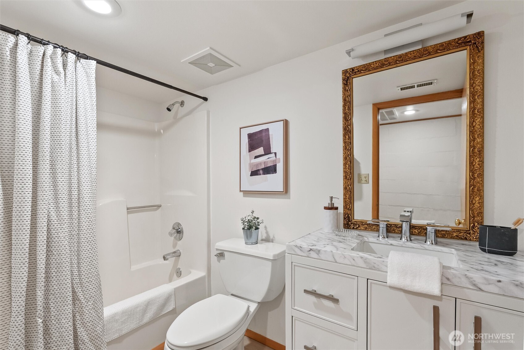 18431 High Street Edmonds, WA 98020 - Photo 28 of 40 a bathroom with a granite countertop tub sink toilet and mirror