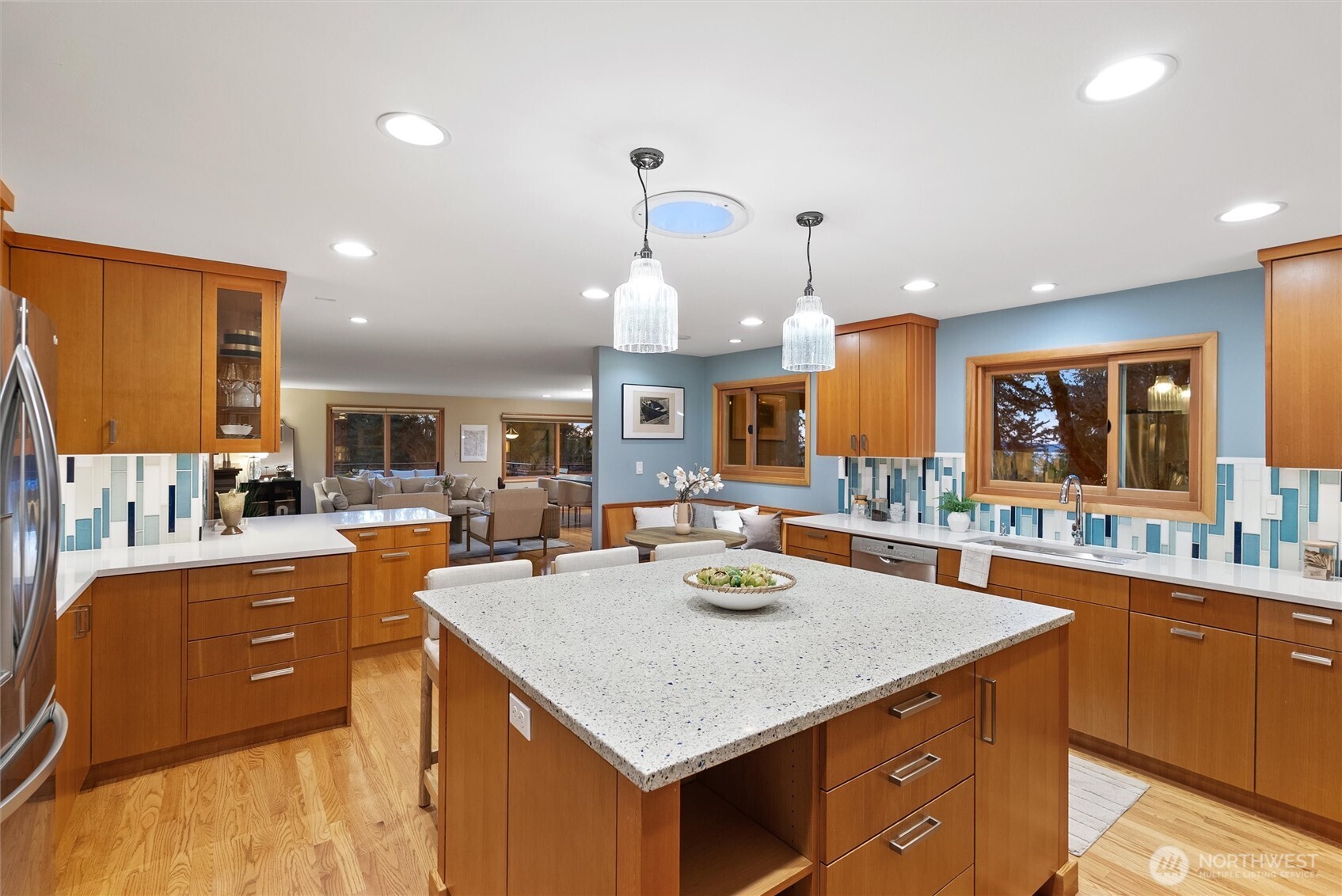 18431 High Street Edmonds, WA 98020 - Photo 7 of 40 a kitchen with a stove a kitchen island a sink and living room