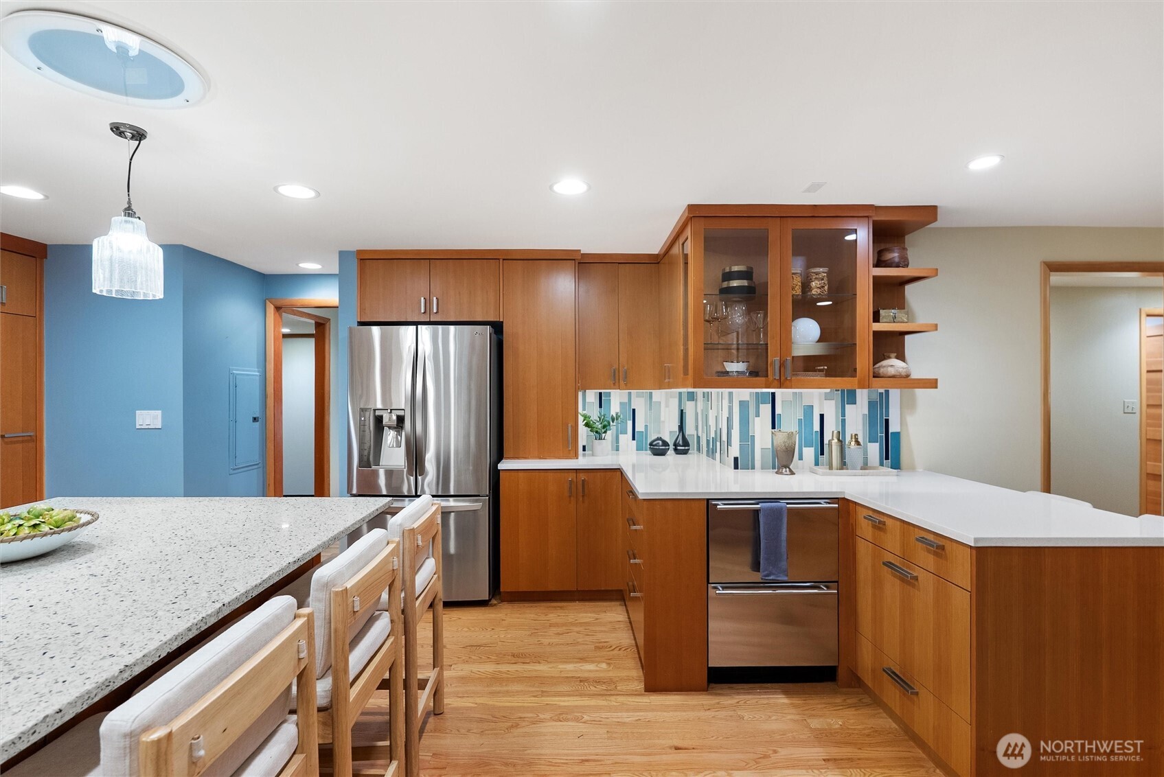 18431 High Street Edmonds, WA 98020 - Photo 10 of 40 a kitchen with stainless steel appliances kitchen island granite countertop a refrigerator a sink dishwasher a dining table and chairs