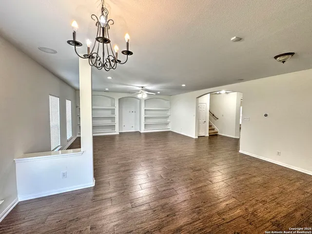 a view of a room with wooden floor