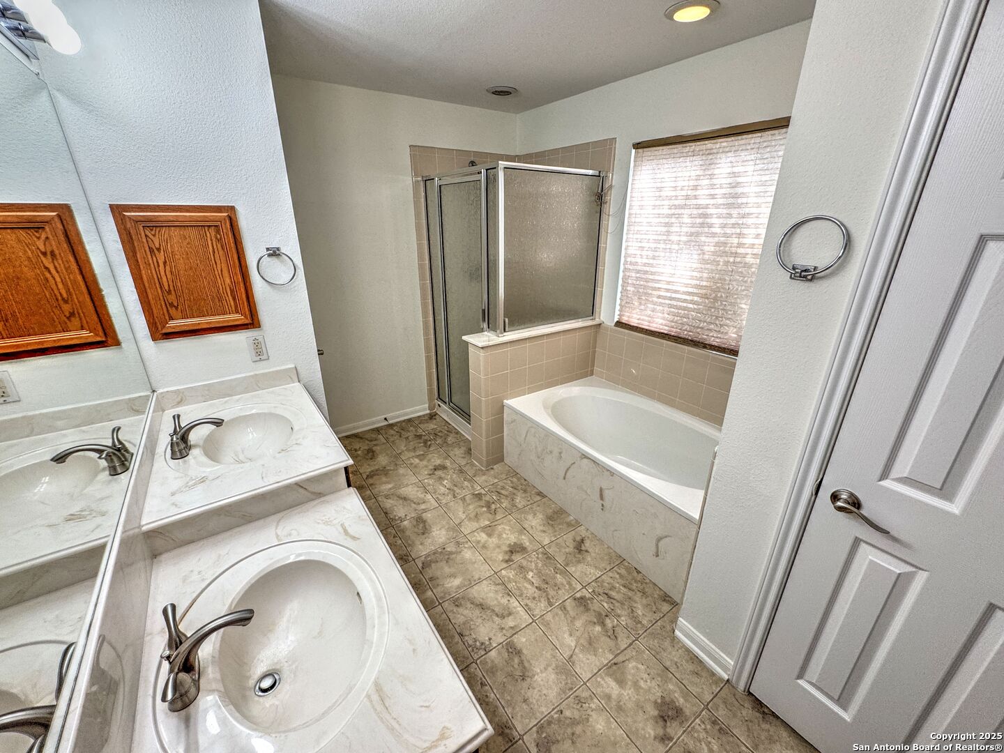 8711 Sandia Circle Helotes, TX 78023 - Photo 21 of 40 a bathroom with a sink a toilet and a mirror