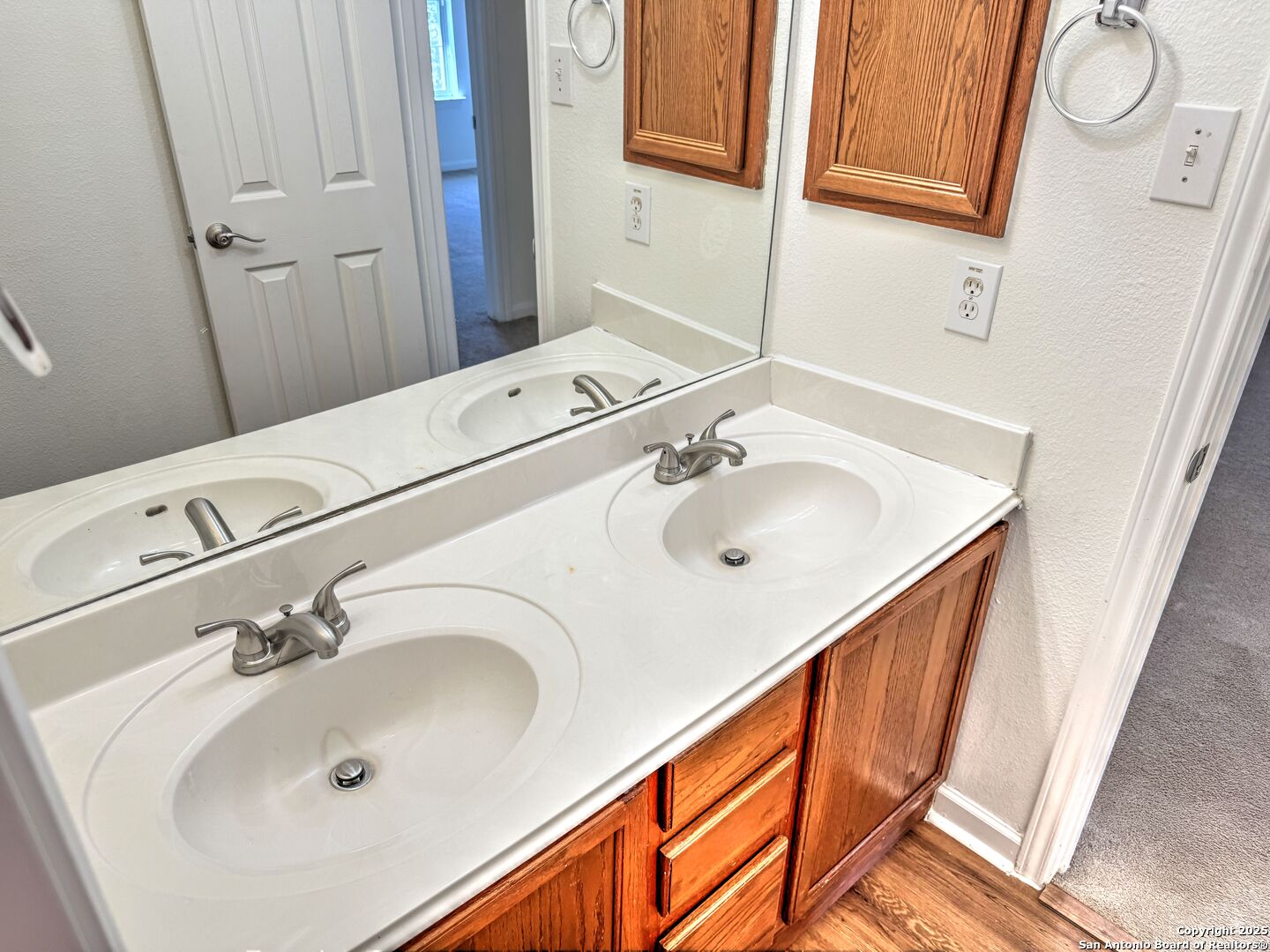 8711 Sandia Circle Helotes, TX 78023 - Photo 28 of 40 a bathroom with a sink and a mirror