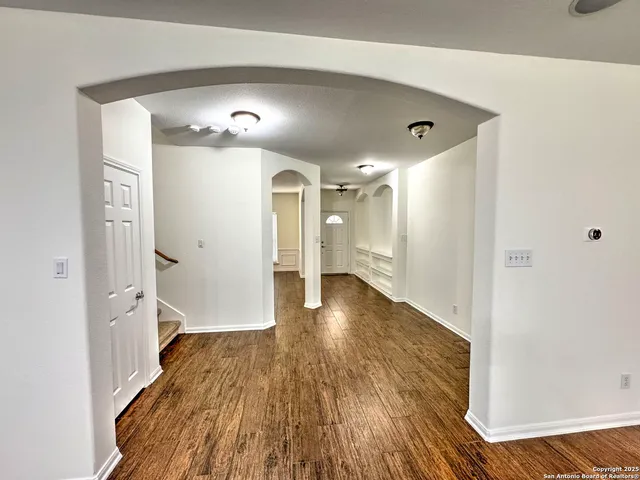 a view of a hallway with wooden floor
