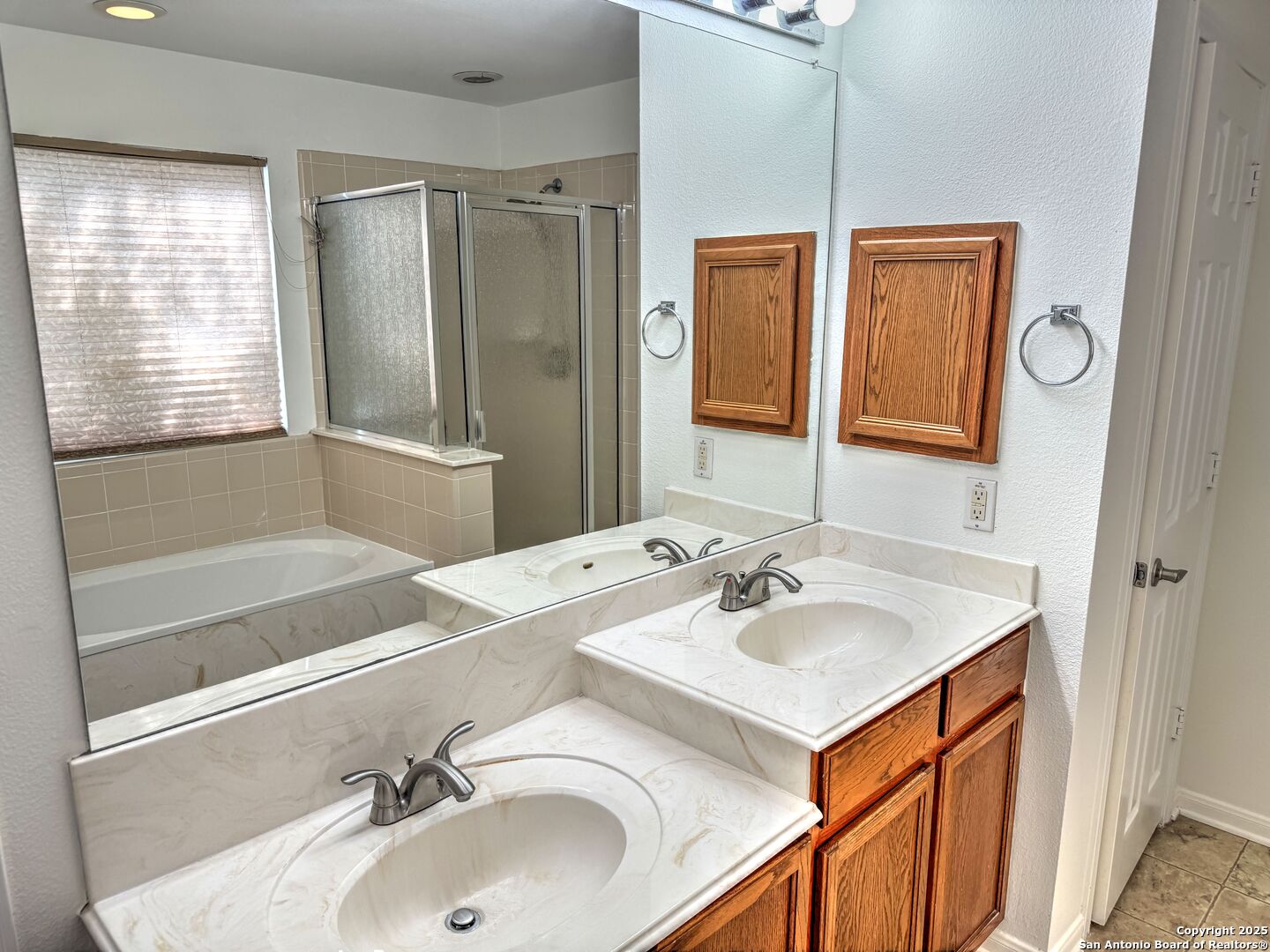 8711 Sandia Circle Helotes, TX 78023 - Photo 32 of 40 a bathroom with a sink and a mirror