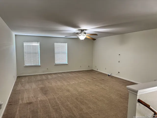 a view of a house with a big yard and large trees