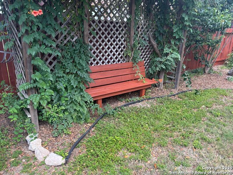 8711 Sandia Circle Helotes, TX 78023 - Photo 39 of 40 a view of a bench in a garden