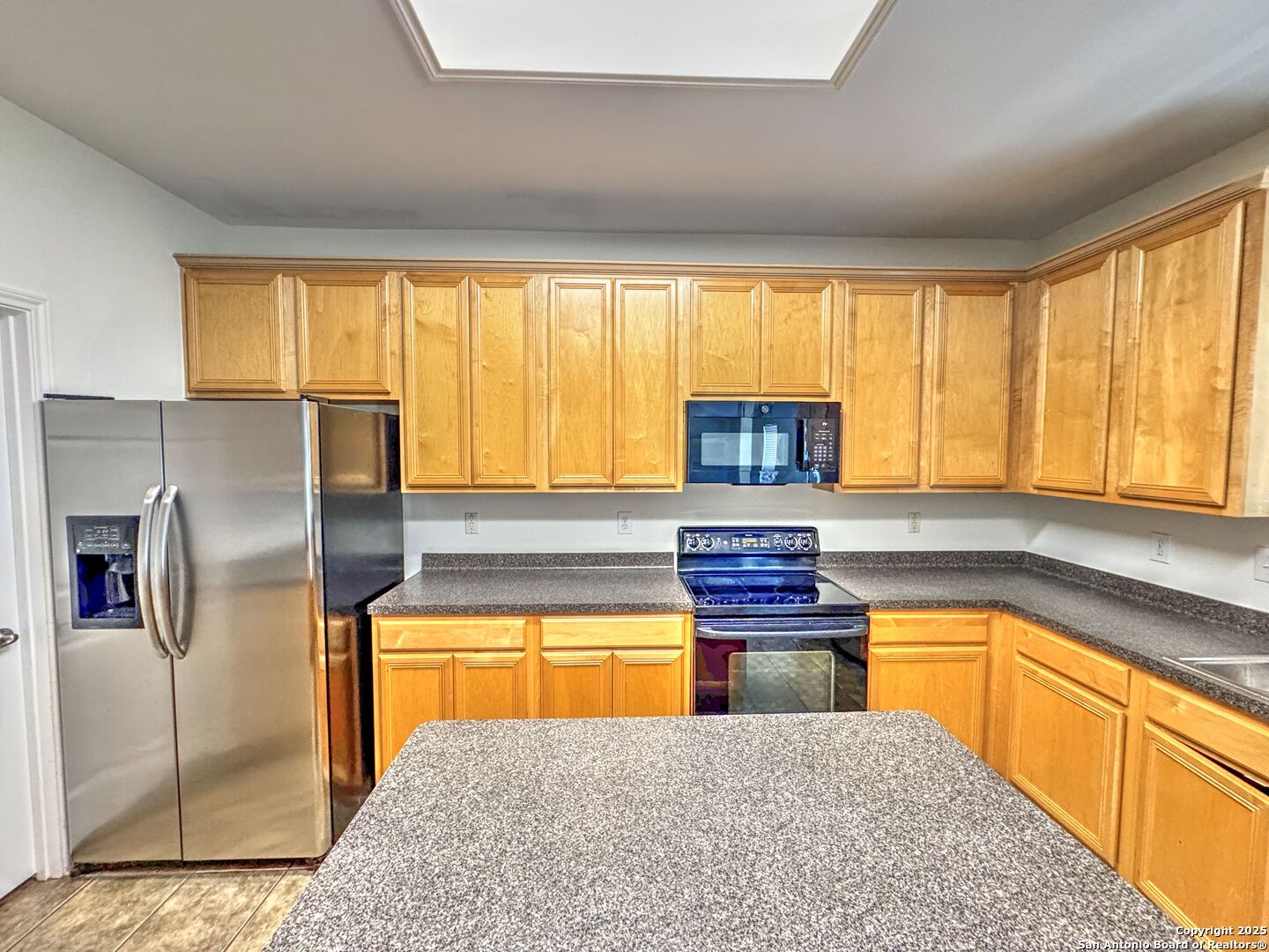 8711 Sandia Circle Helotes, TX 78023 - Photo 5 of 40 a kitchen with stainless steel appliances granite countertop a stove a sink refrigerator and microwave