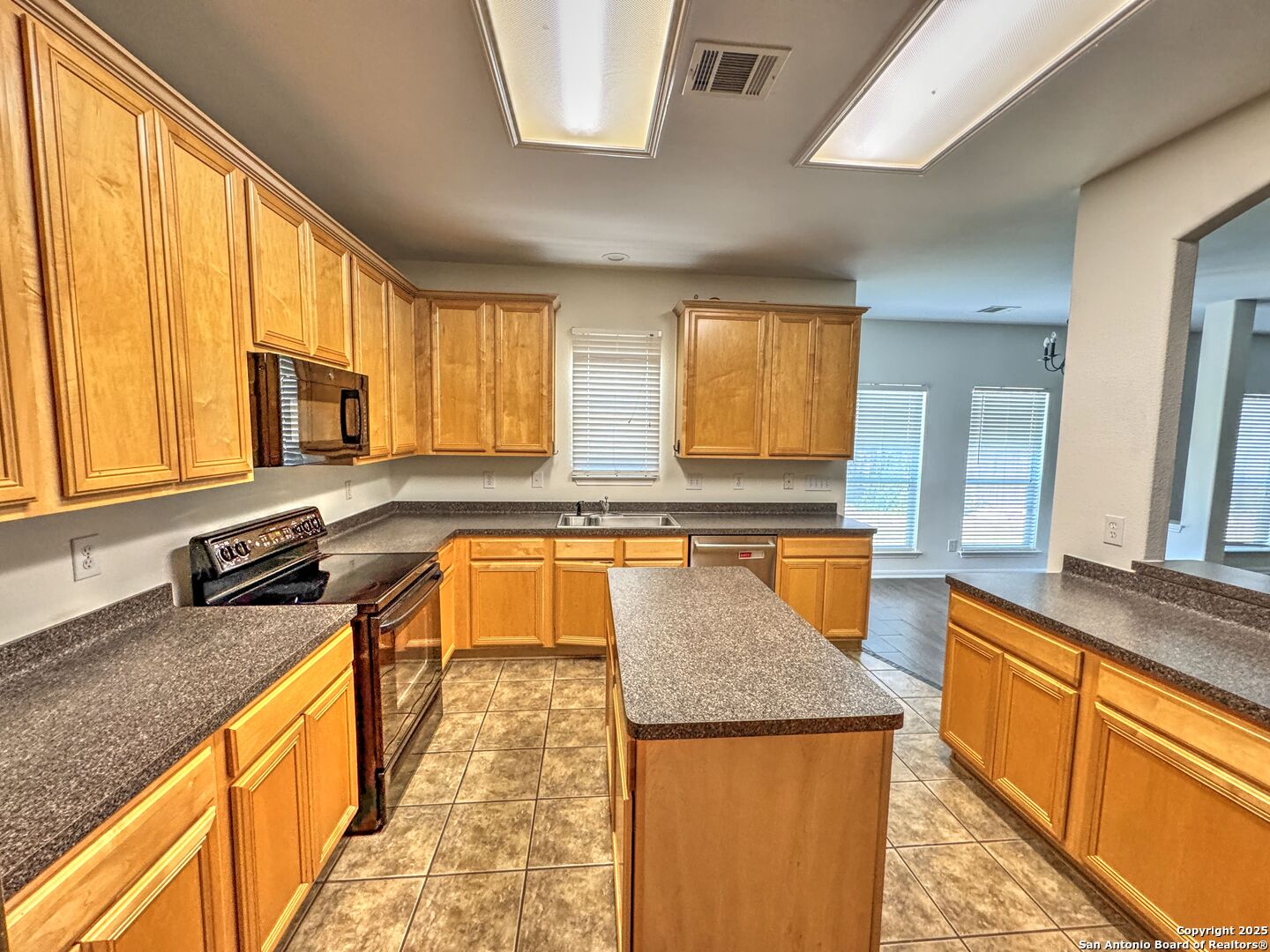 8711 Sandia Circle Helotes, TX 78023 - Photo 6 of 40 a kitchen with stainless steel appliances granite countertop sink stove top oven and cabinets
