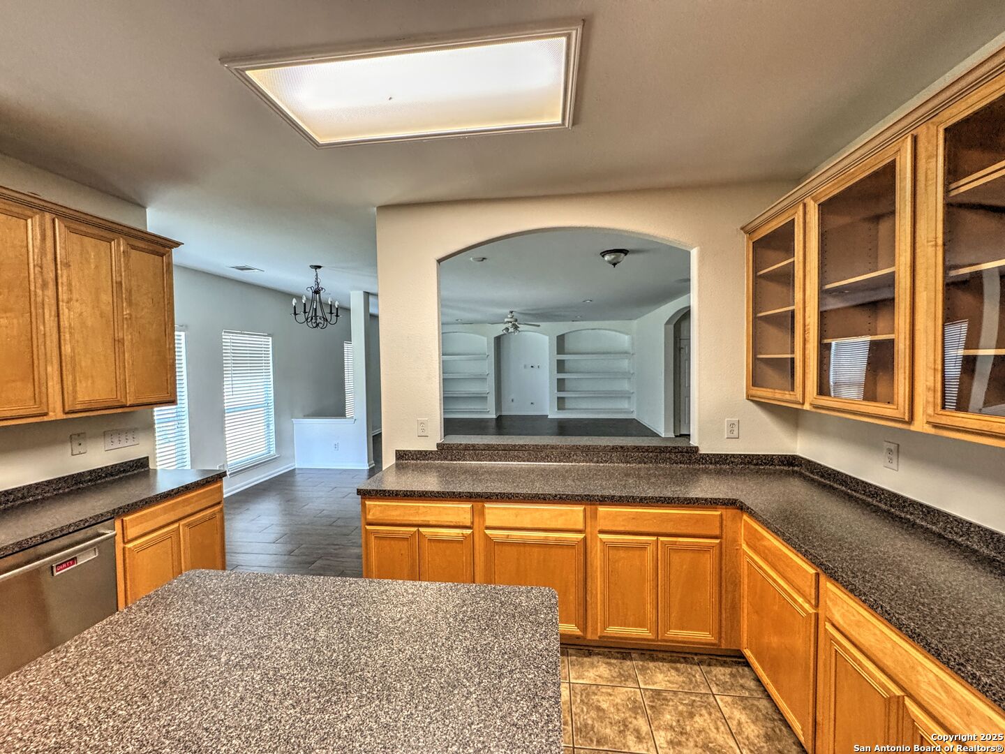 8711 Sandia Circle Helotes, TX 78023 - Photo 7 of 40 a view of a kitchen with a sink and living room