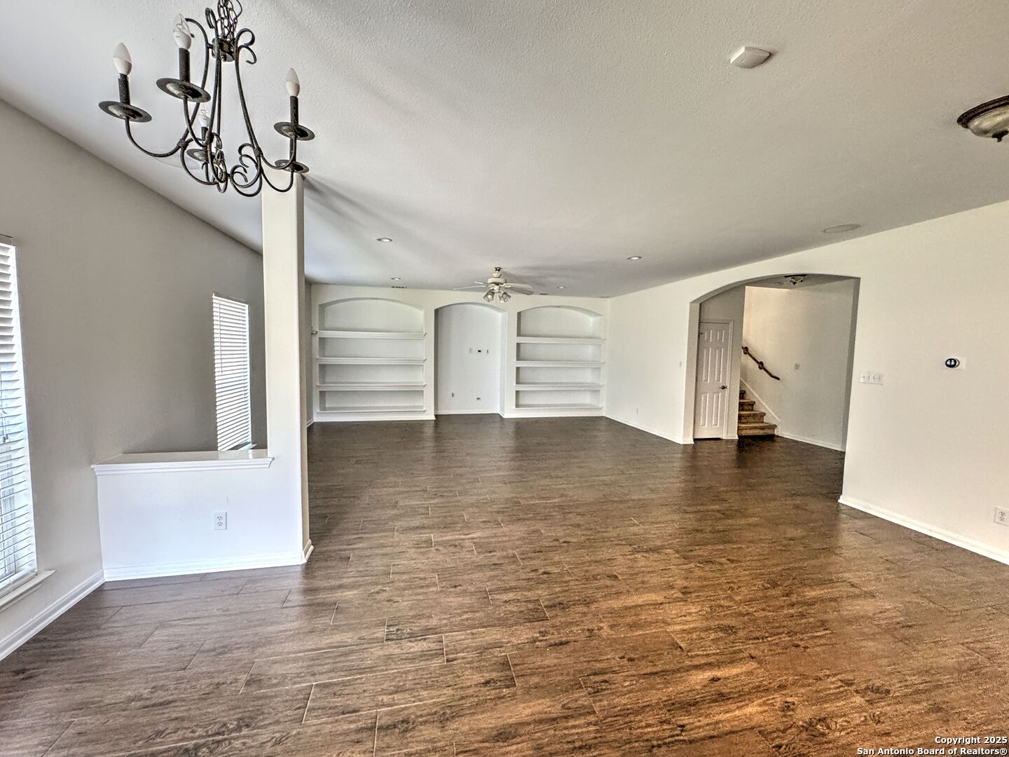 8711 Sandia Circle Helotes, TX 78023 - Photo 8 of 40 a view of empty room with wooden floor and fan