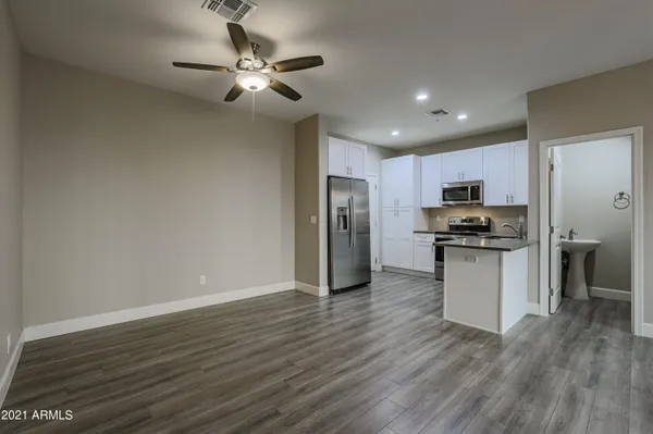 a view of kitchen with refrigerator microwave and stove top oven