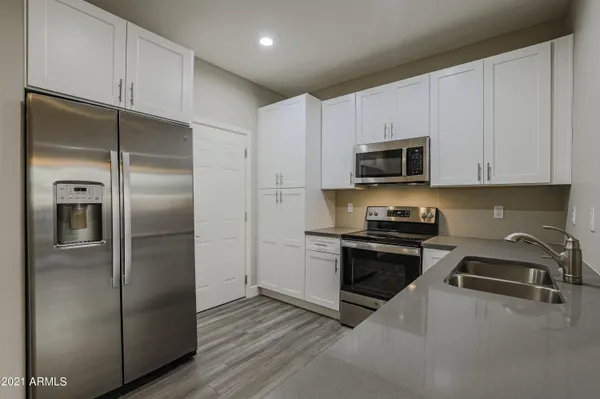 a kitchen with a refrigerator stove and microwave