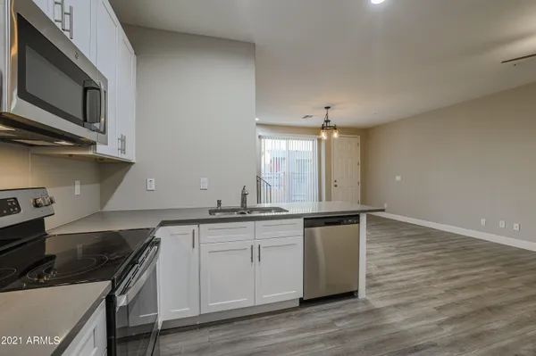 a kitchen with stainless steel appliances granite countertop a sink and stove top oven