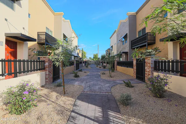 a view of a patio with table and chairs potted plants