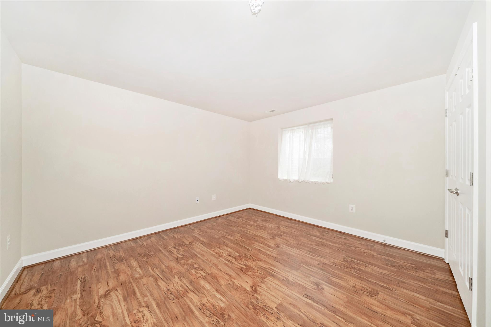 3156 Sumantown Road Middletown, MD 21769 - Photo 44 of 62 an empty room with wooden floor and windows