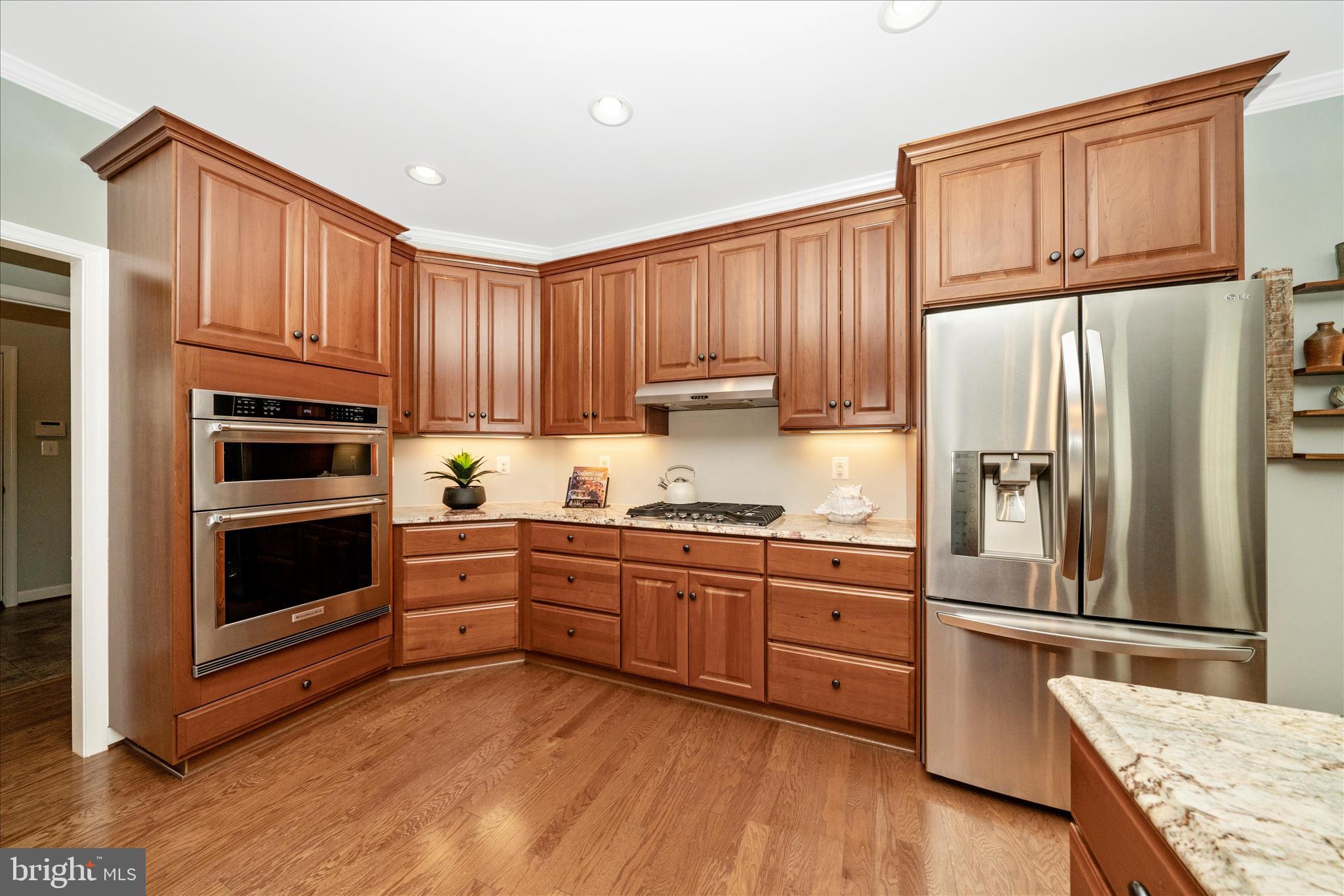 3156 Sumantown Road Middletown, MD 21769 - Photo 9 of 62 a kitchen with granite countertop wooden cabinets and stainless steel appliances