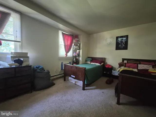 a bathroom with a sink a toilet and shower curtain